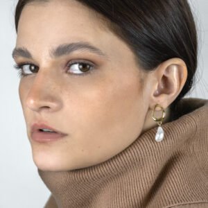 woman wearing pearl drop earrings with a subtle look.
